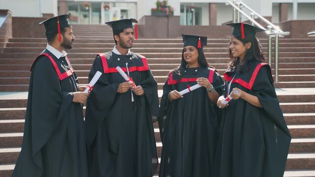 Group of diverse graduates celebrating their university graduation day