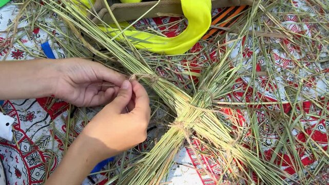 weaving a straw doll