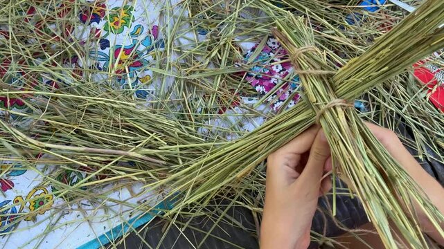 weaving a straw doll
