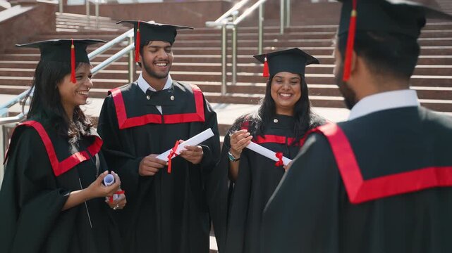 Happy graduates celebrating together with diplomas