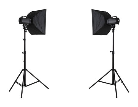 Pair of professional studio lighting equipment with softboxes on adjustable stands, positioned symmetrically, isolated on a transparent background, ideal for photography and videography setups.