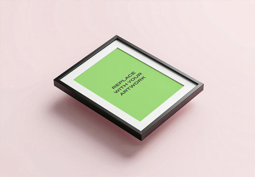 Framed poster mockup with black frame and white mat, placeholder text displayed at an angle on a light pink surface, realistic wall art presentation template for graphic design print