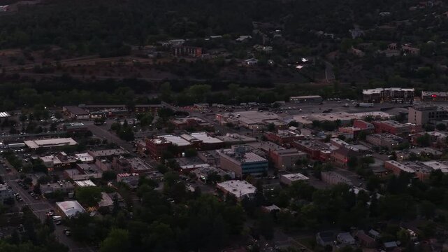 Aerial of downtown Durango Colorado commercial core at dusk with dense forest in summer