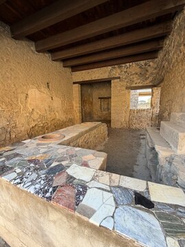 Colorful marble mosaic counter of ancient Roman thermopolium, Pompeii, Italy