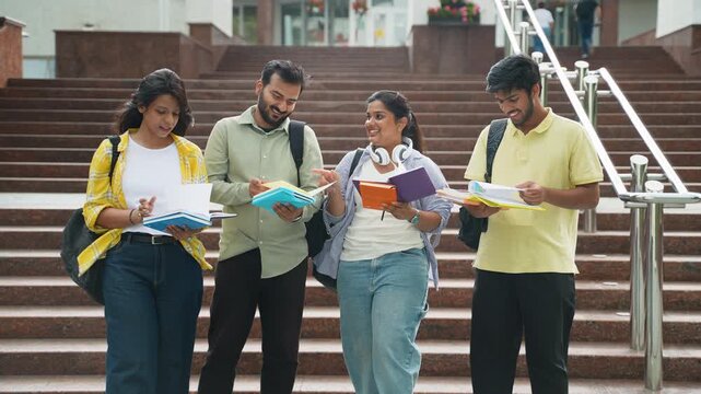 Group of indian students discussing homework on campus stairs