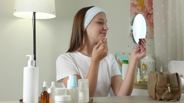 Teenage girl wearing under-eye patches and enjoying her daily skincare routine at home. Teen skincare, facial care, self care, healthy skin and beauty routine concept. 