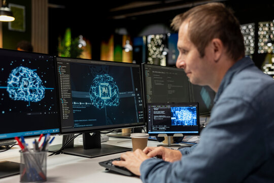 Man uses artificial intelligence on a computer to optimize performance and forecast issues while training deep learning models for automatic updates in a technology company office.