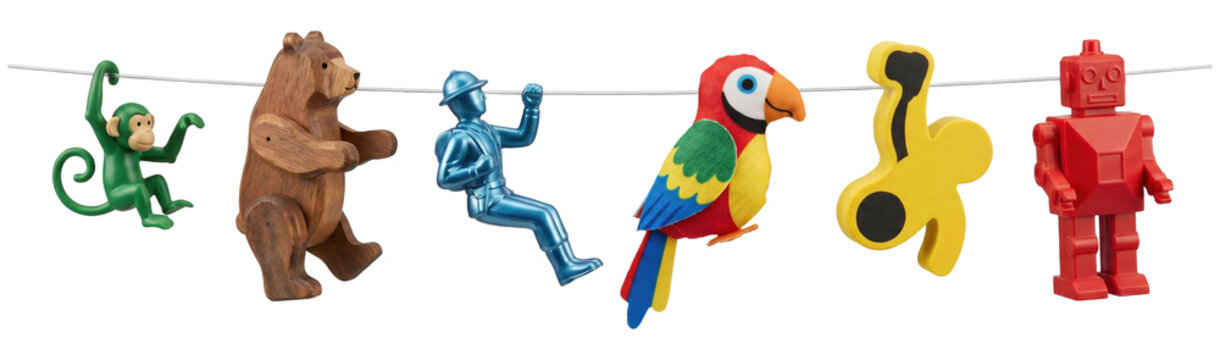 Diverse collection of vintage children's toys including a plastic monkey, wooden bear, soldier, fabric parrot, and red robot hang together in a playful, colorful lineup