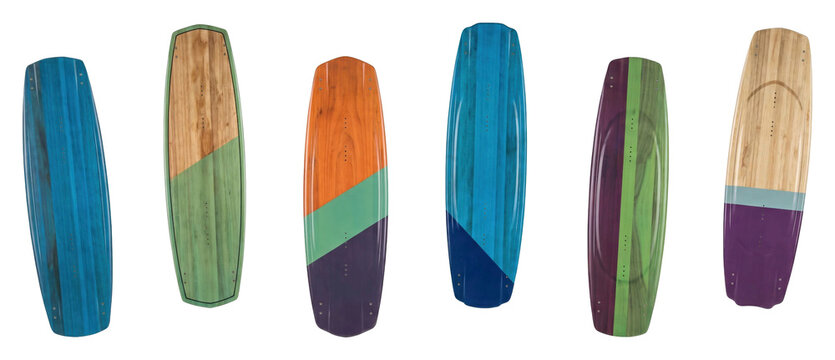 Six colorful wooden wakeboard decks with glossy finishes and vibrant geometric patterns are arranged in a neat row, showcasing modern equipment for extreme water sports
