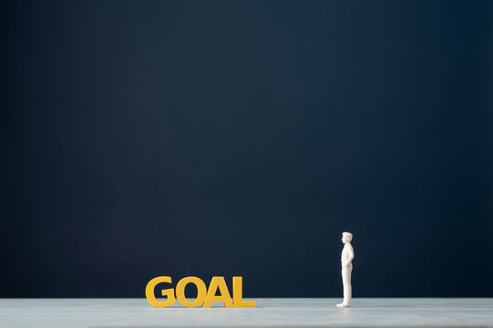 Goal setting and achievement concept with person facing the word goal