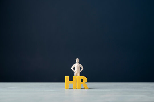 Human resources HR concept with business person and yellow letters