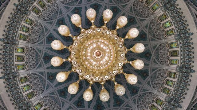 Crystal chandelier and decorative ceiling inside Sultan Qaboos Grand Mosque in Muscat Oman, 4k mosque interior video