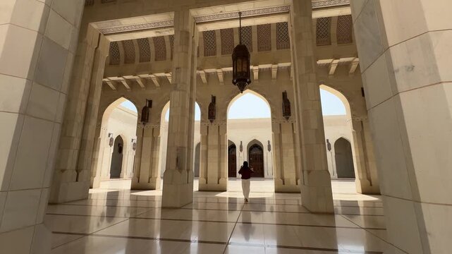 Elegant arches and colonnade inside Sultan Qaboos Grand Mosque in Muscat Oman