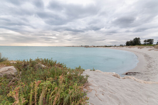 Sandy beach near Perth beneath dramatic cloudy sky