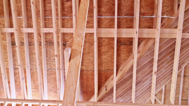 Wooden beams trusses are as construction takes place in new house, progress of building work.