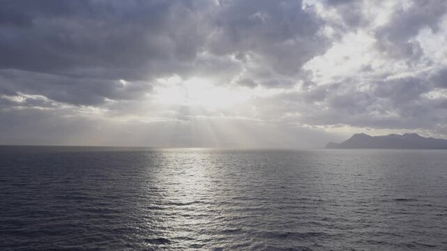 Beautiful Sun Rays Shine Through Clods Over the Ocean. View From Cruise Ship. South American Epic View Nature Vacation Landscape in Distance Mountains