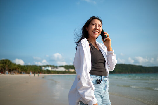 Trendy young traveler enjoying sunny weather and coastal breeze on a luxury tropical island resort