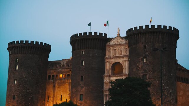 Silhouette of Naples Castle Nuovo at sunset from the seafront