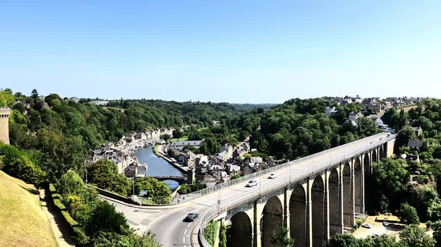 Viaduct bridge with cars crossing over a river and historic town Dinan, France. Perfect for travel blogs, infrastructure articles, and tourism brochures.
