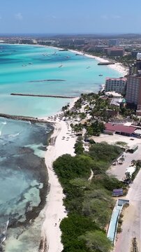 Palm Beach In Oranjestad Caribbean Netherlands Aruba. Aerial View Of A Bustling Downtown Cityscape With Modern Buildings. Tropical Skyline. Seaside Beach. Oranjestad Caribbean Netherlands.