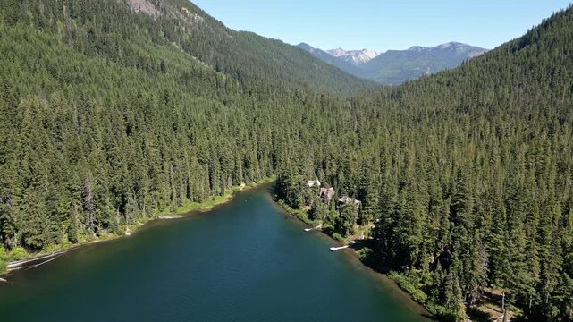 Lake with evergreen forest landscape. Landscape of mountain and forest lake. Nature landscape. Lake in scenic nature. Scenic forest nature at hiking lake. Mountain green forest