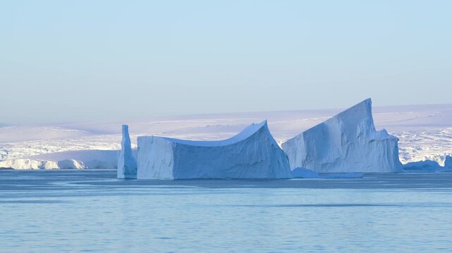 Huge Tabular Iceberg in Antarctica at Sunset. Beautiful Snow Covered Mountains Epic Nature Remote Destination. Incredible Panoramic Vista Travel