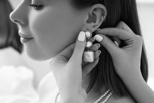 Elegance and luxury fashion, woman putting on pearl earrings and necklace, bridal jewelry and beauty