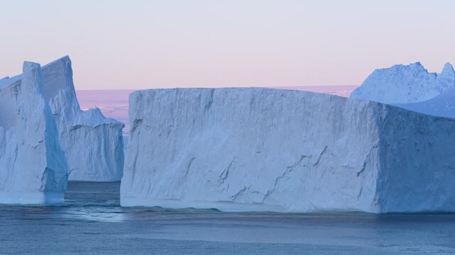 Antarctica Huge Tabular Icebergs at Sunset. Beautiful Snow Covered Mountains Epic Nature Remote Destination. Incredible Massive Ice Floating.