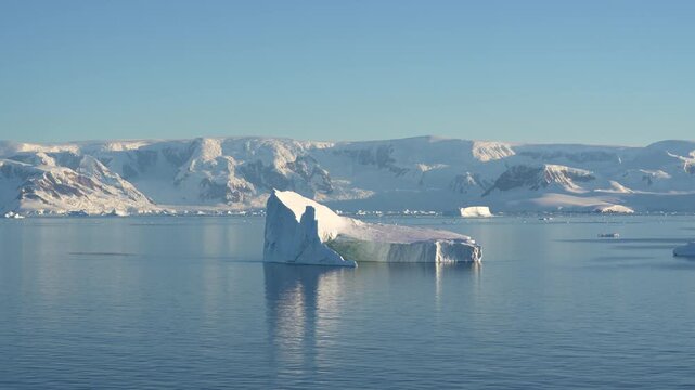 Antarctica Wide View of Huge Tabular Iceberg with Beautiful Landscape of Mountains Covered in Snow, Ice, Glaciers Behind. Remote Nature Frozen Region