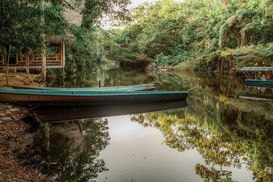 Tena, Ecuadorian Amazon. October 11, 2023. A captivating view of a long wooden canoe&mdash;carved from a single log&mdash;moored at the riverbank, ready to navigate the calm waters of Tena.
