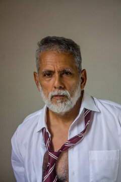 Mature Handsome Man Facing Camera in Open Collar Shirt