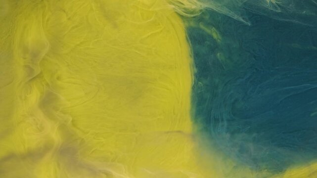 Paint spreads underwater in vibrant colors and shapes