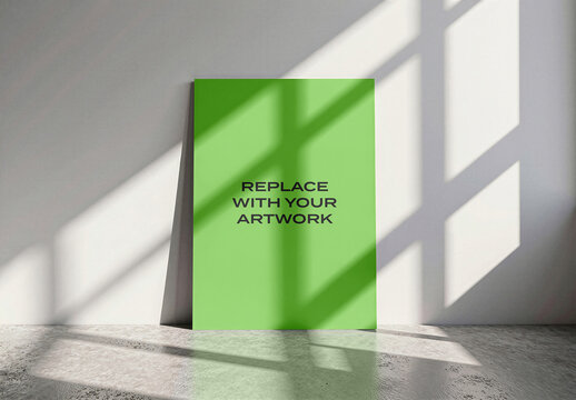 Vertical poster mockup leaning against a wall in minimalist interior with natural light from window, realistic art presentation on concrete floor shadows