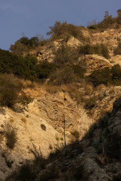Sunset light streams through the mountains of San Gabriel Canyon above Azusa, California, USA.