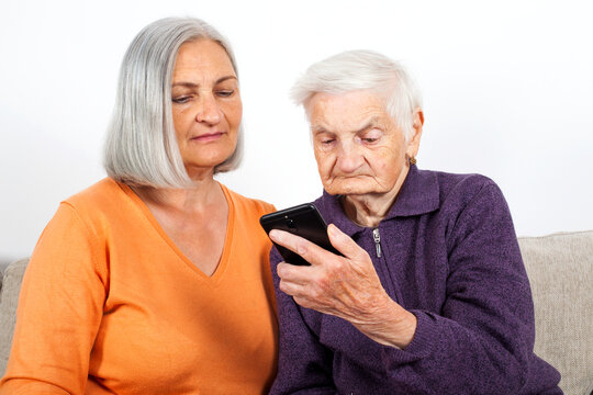 Senior Woman Learning to Use Smartphone with Caregiver Support