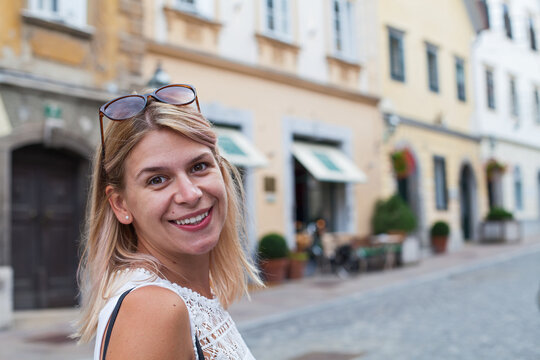 Smiling Female Tourist on a Charming European Stree