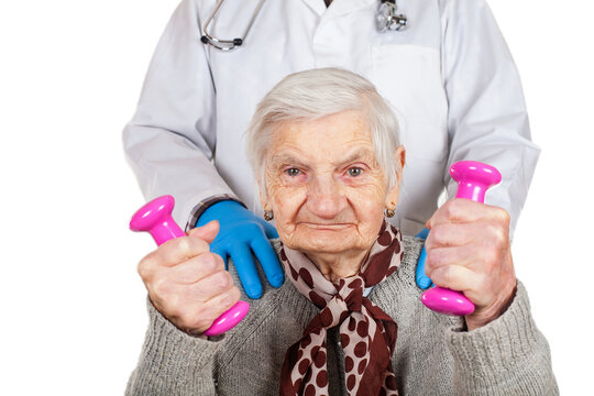 Senior Woman Exercising with Dumbbells Under Medical Supervision