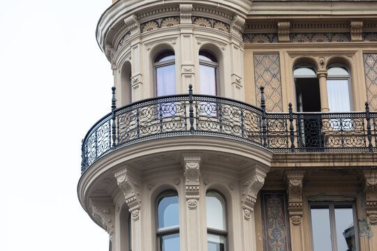 Ornate Historic Building Facade with Curved Wrought Iron Balcony