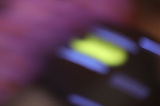 Close-up of colorful illuminated keys displaying vibrant purple yellow blue and black tones