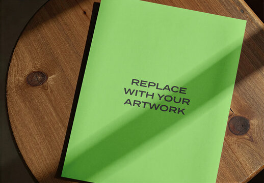 Brochure mockup with placeholder text displayed on a round wooden table, realistic print presentation for branding and editorial layout, natural lighting shadow, interior scene
