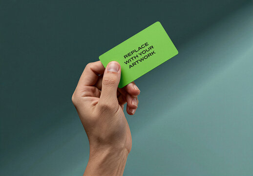 Business card mockup held in hand against gradient background, realistic stationery branding presentation with placeholder text for graphic design display, vertical orientation, close-up view