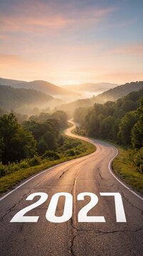 2027 new year concept on a winding road through green mountains at sunrise, symbolizing future journey, new beginnings, goals, opportunity, success, progress, travel, and forward direction.