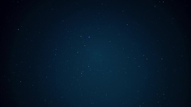 Dark blue night sky showing numerous stars and cosmic dust, creating a feeling of infinity and space