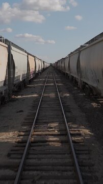 Freight train cars in kansas yard inside in between low vertical video