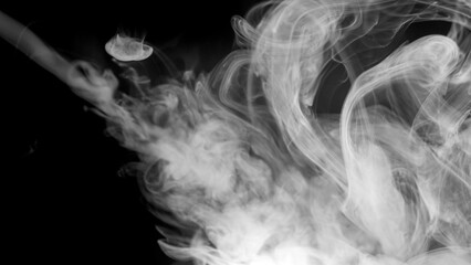 A soft, diffused cloud of white smoke drifts languidly, creating an ethereal and atmospheric texture against the black void. © Ahmad Khan