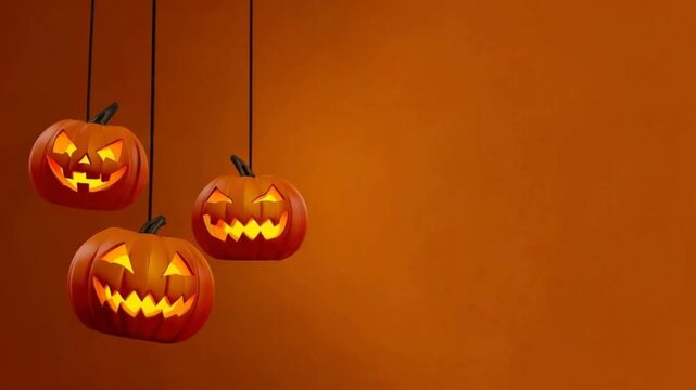 Scary Hanging Jack-O'-Lantern Pumpkins on Warm Orange Halloween Background with Copy Space