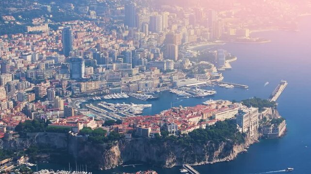 The video features Monacos harbor with luxury yachts and buildings along the coastline. The footage highlights daytime activity and the vibrant city life of this famous location.