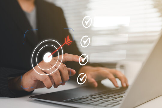 Business goal setting and task management. professional interacts with a digital checklist and target icon, representing productivity, goal achievement, and strategic planning.