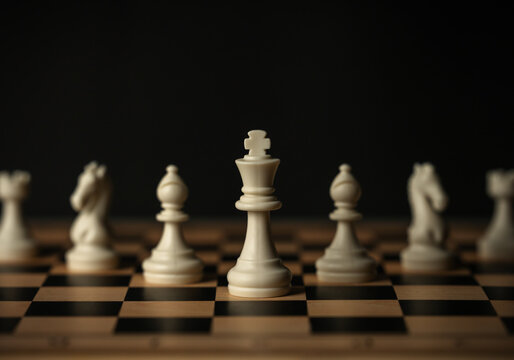white chess pieces aligned on wooden board, on black background