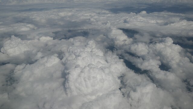 Aerial View of Dense White Clouds from an Airplane